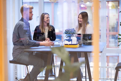 Three colleagues having a meeting and are happy