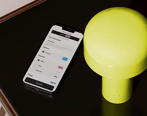 Iphone lying on a table showing Kustom's checkout